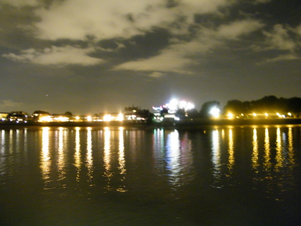 The view of London at night across the Thames.
